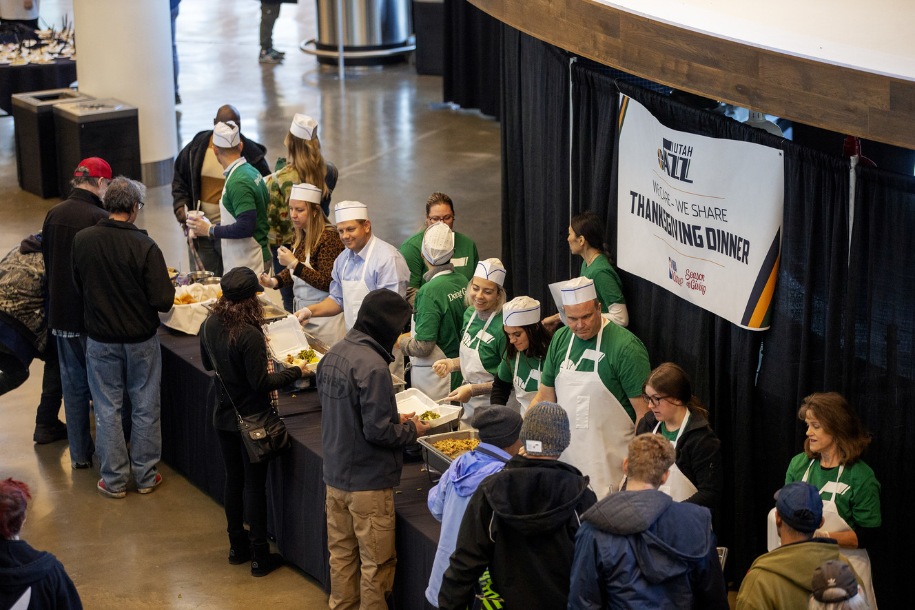 Members of the Utah Jazz organization and the Larry H. Miller Group of Companies dish up food during the 20th annual We Care - We Share Thanksgiving Meal for local homeless and low-income individuals at the Vivint Smart Home Arena in Salt Lake City on Monday, Nov. 19, 2018. (Photo: Scott G Winterton, KSL)