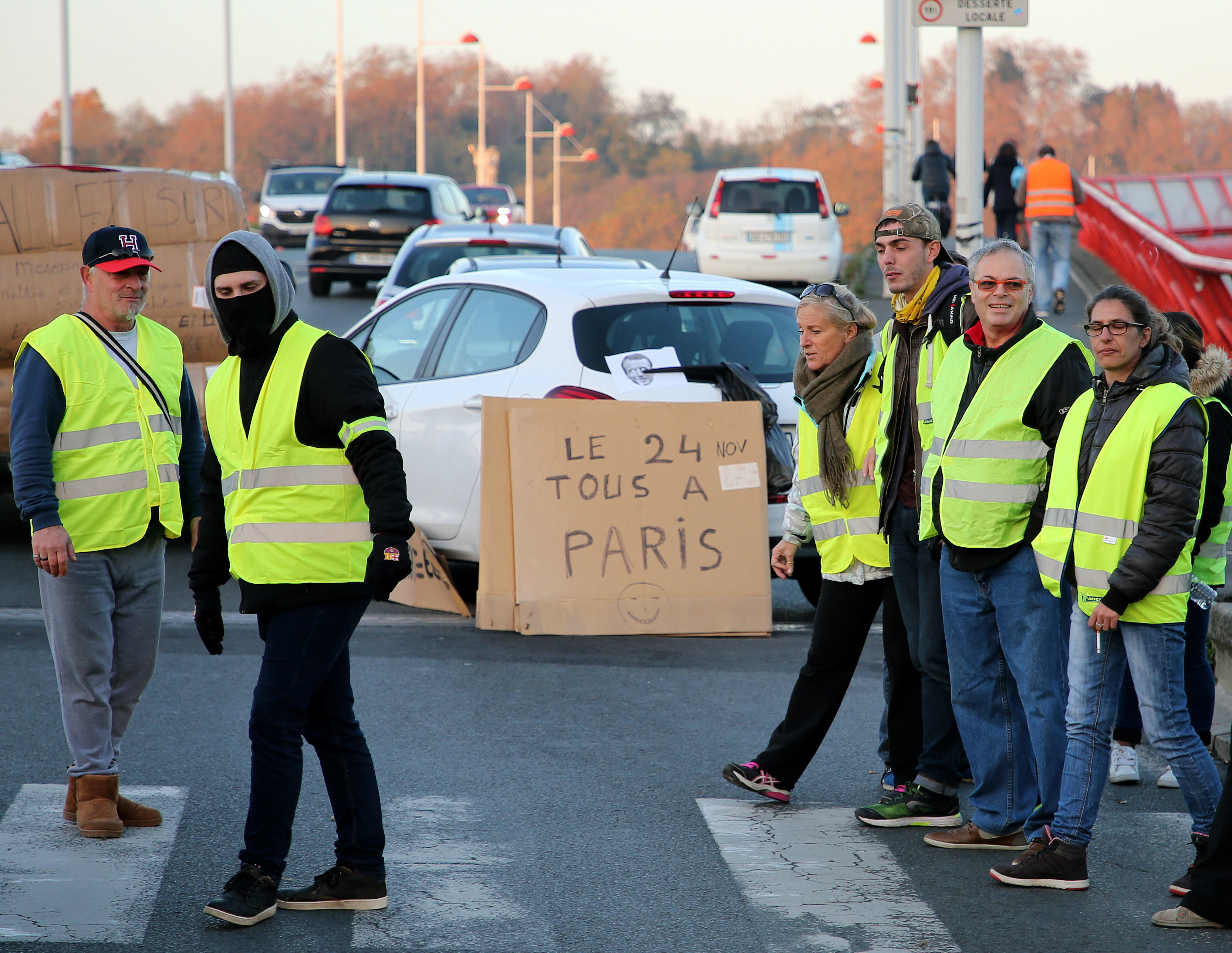 Macron urges dialogue amid protests, defends gas tax hikes