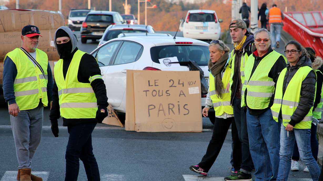 Macron urges dialogue amid protests, defends gas tax hikes