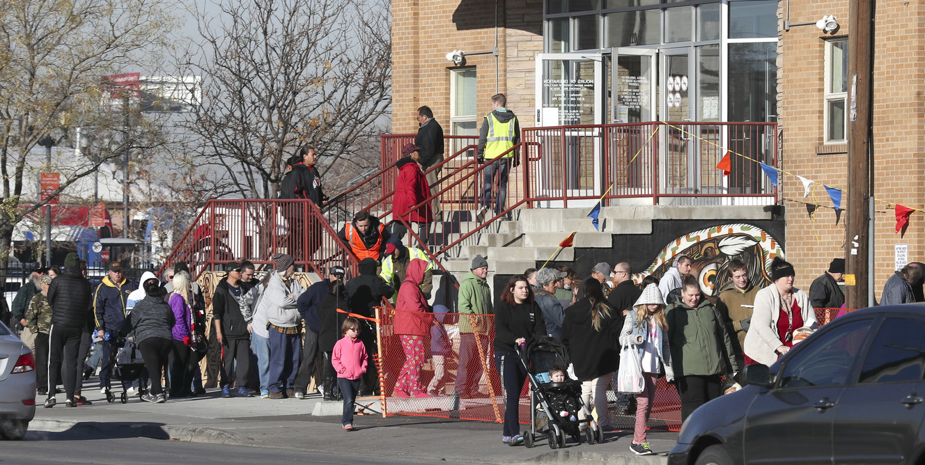 People leave the Crossroads Urban Center in Salt Lake City where 3,700 turkeys and side dishes were distributed to low-income Utahns on Wednesday, Nov. 21, 2018. (Photo: Steve Griffin, KSL)