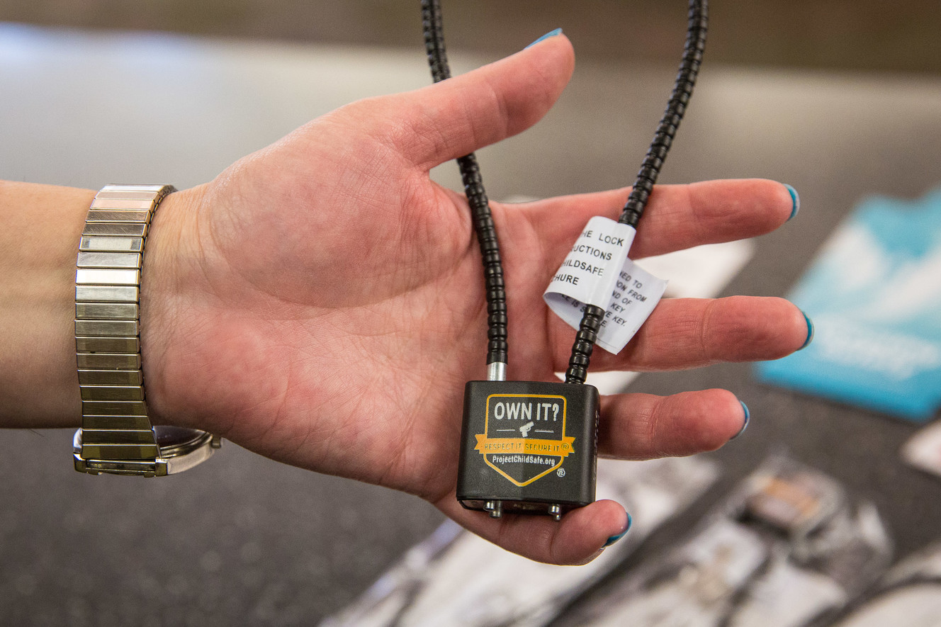 Stephanie Jewett, manager of Columbus Library in South Salt Lake, shows a free gun lock at the library on Tuesday, Nov. 20, 2018. Salt Lake County libraries are handing out the locks to prevent suicide and protect children. (Photo: Qiling Wang, KSL)