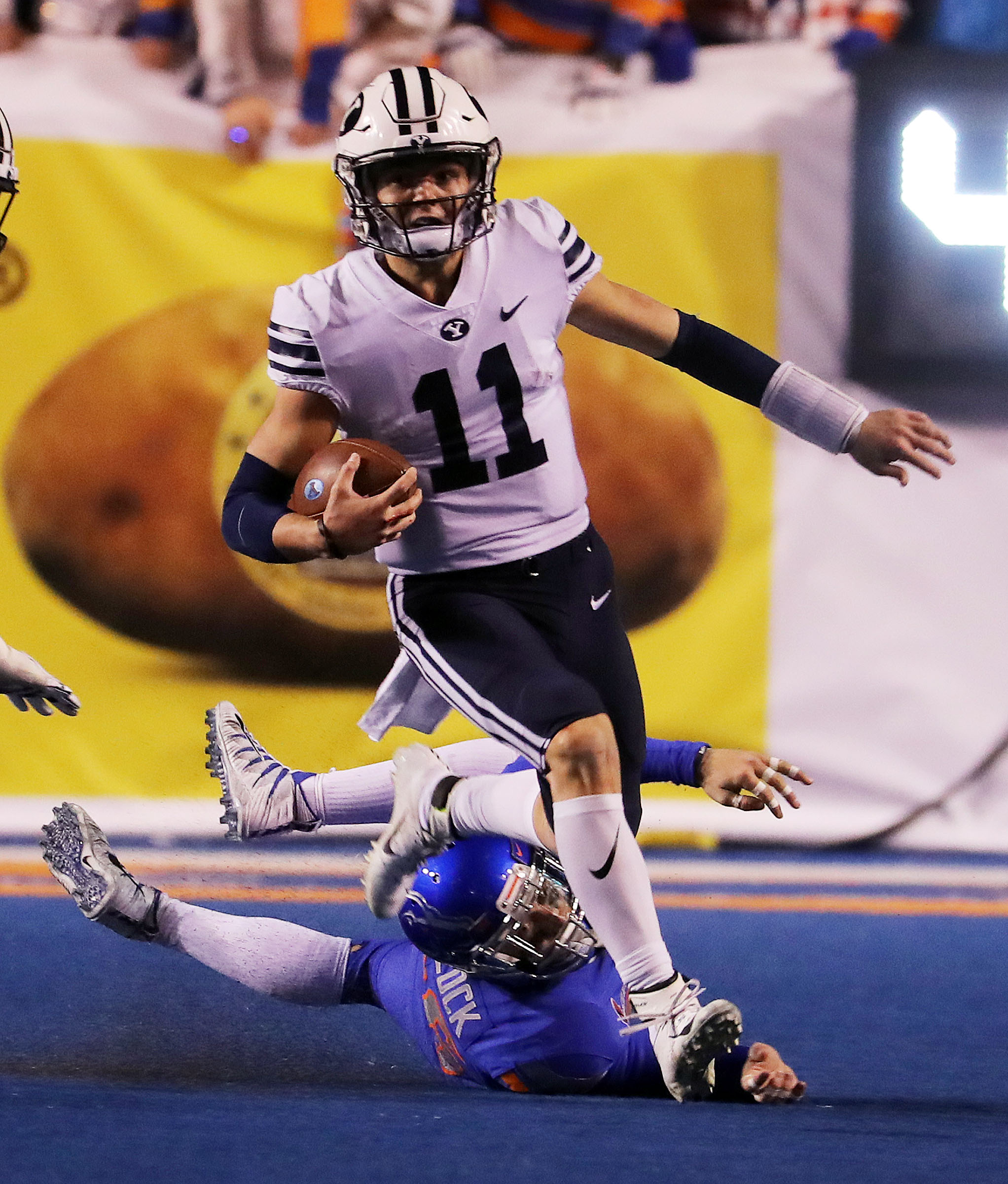 BYU quarterback Zach Wilson runs the ball with Boise State linebacker Blake Whitlock defending during NCAA football in Boise on Saturday, Nov. 3, 2018. (Photo: Ravell Call, Deseret News)