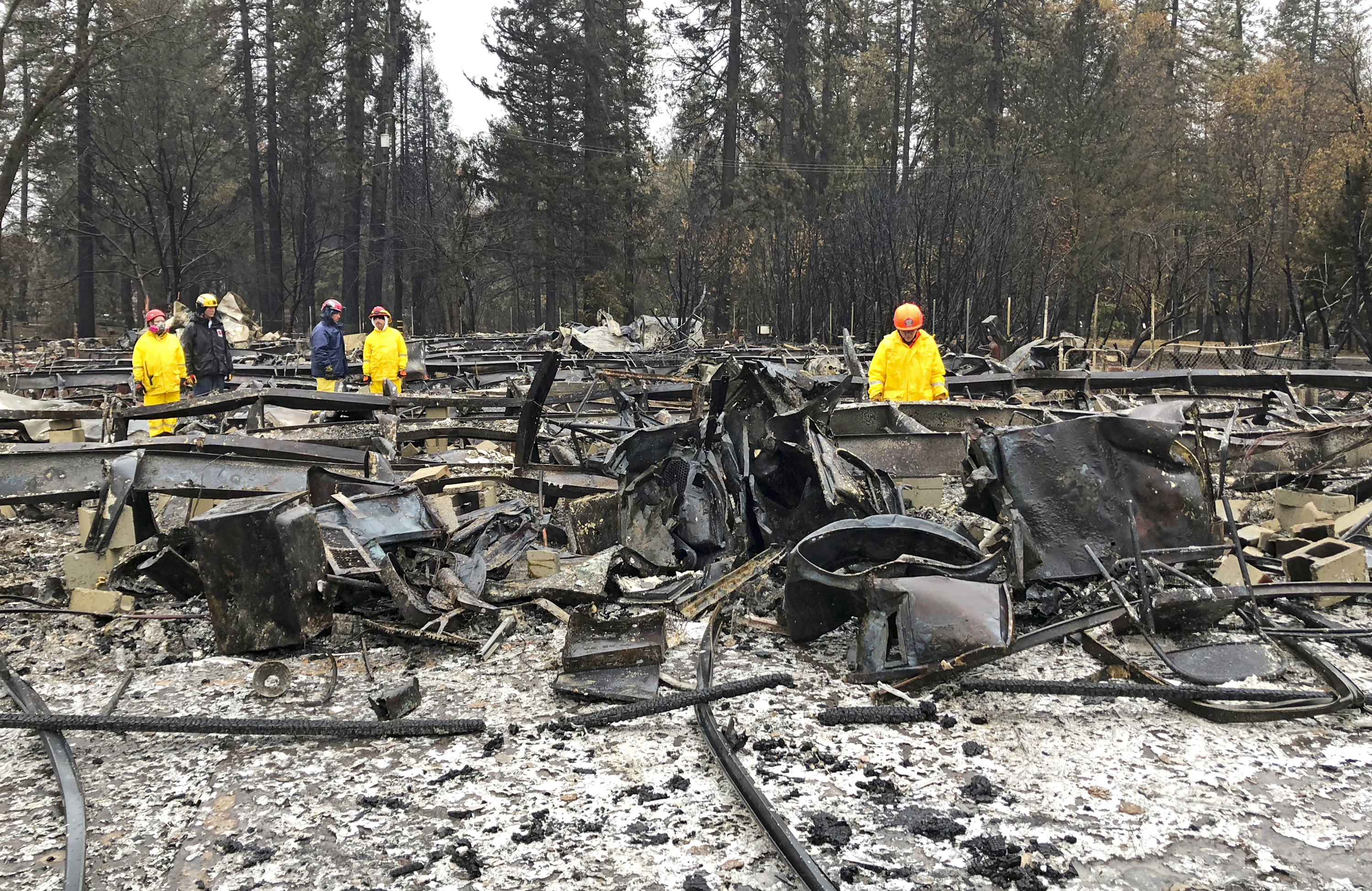 Rain tamps down California fire but turns grim search soggy