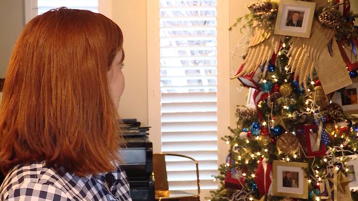 Jennie Taylor looks back at a Christmas tree that North Ogden community members dropped off at her home in honor of her husband, North Ogden Mayor Brent Taylor, a major in the National Guard who was killed in Afghanistan, on Saturday, Nov. 24, 2018. (Photo: KSL TV)