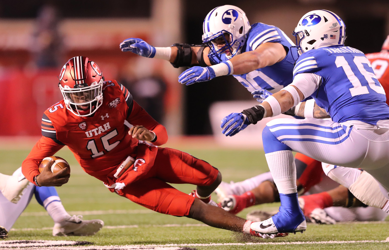 Utah quarterback Jason Shelley (15) falls to the ground as BYU defensive lineman Corbin Kaufusi (90) and BYU linebacker Sione Takitaki (16) rush in as BYU and Utah play at Rice Eccles Stadium in Salt Lake City on Saturday, Nov. 24, 2018. (Photo: Scott G Winterton, KSL)