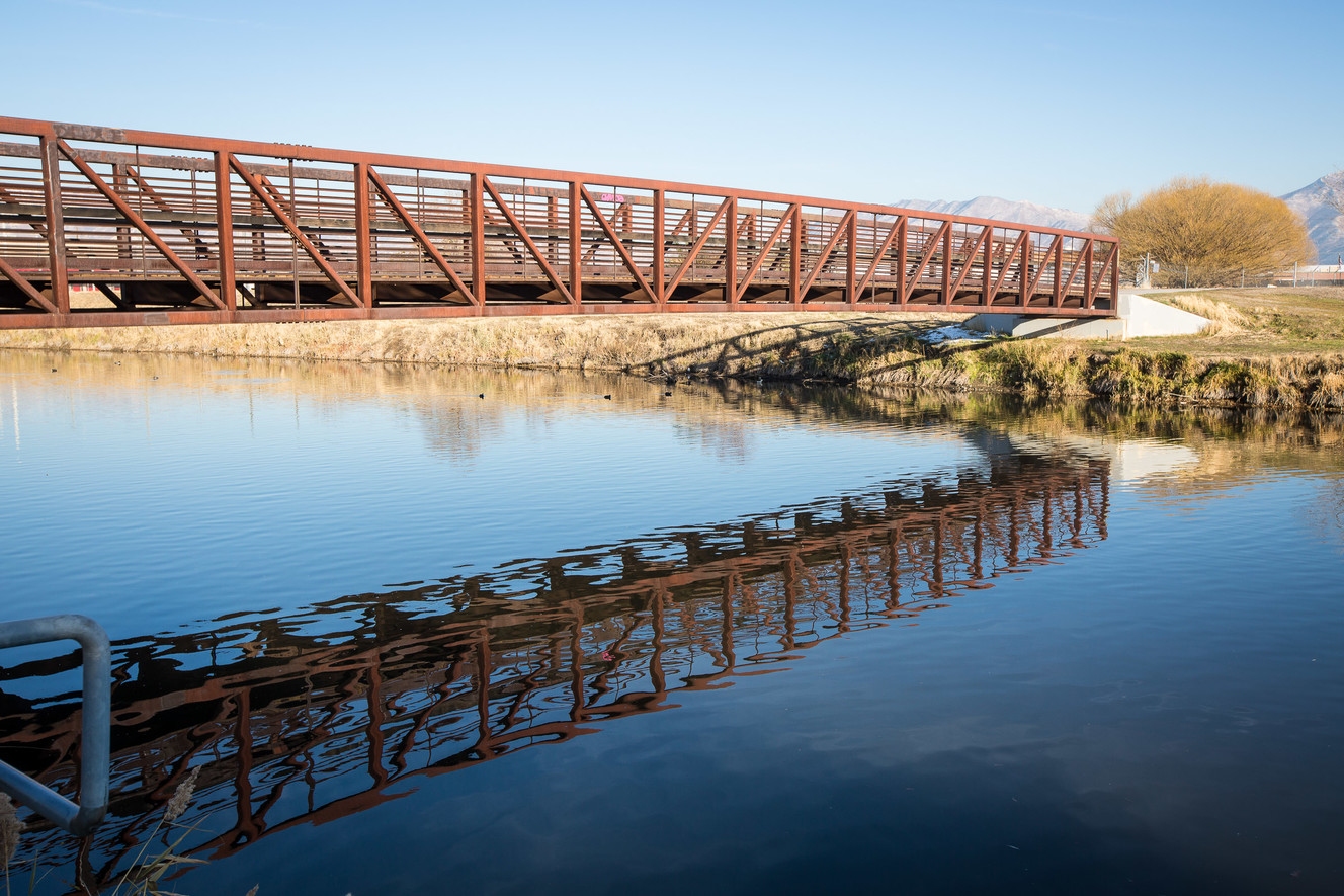 A bridge is reflected in the Jordan River in West Valley City on Monday, Nov. 26, 2018. A coalition of city and county leaders announced Monday they're taking the next steps to form the Jordan River Park. (Photo: Qiling Wang, KSL)
