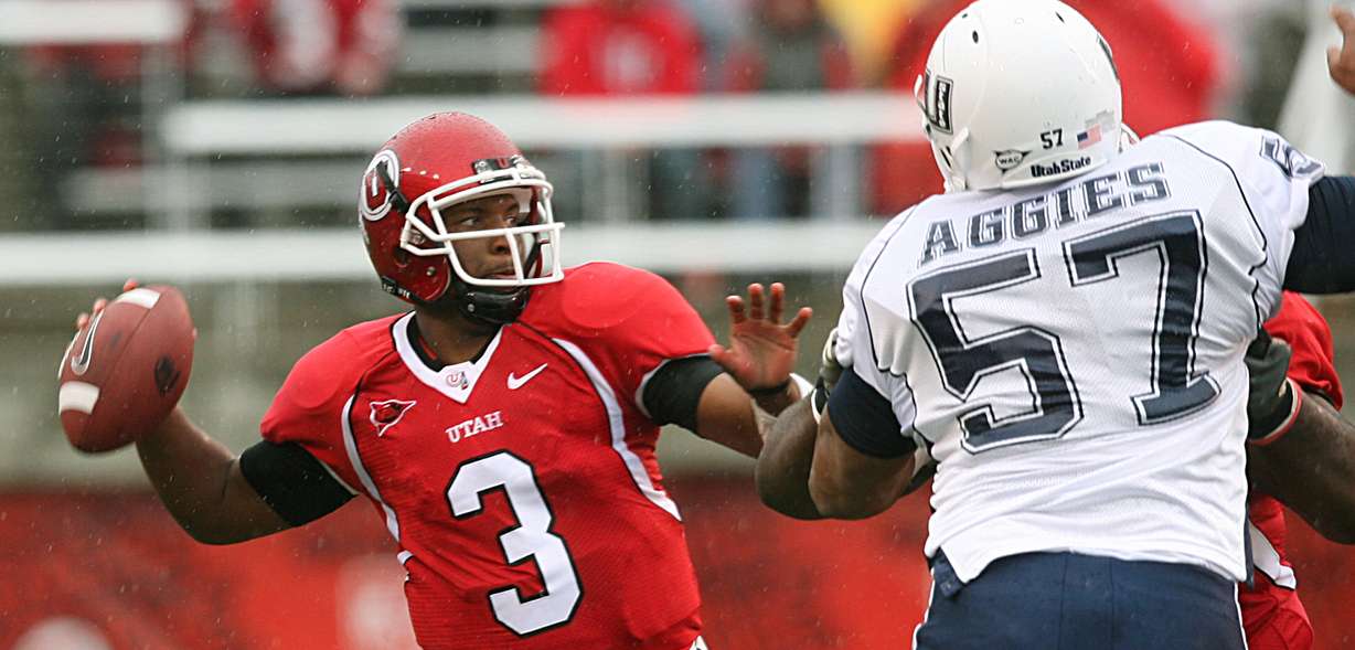 Utah's Brian Johnson (left) throws the ball against Utah State's Frank Maile at Rice-Eccles Stadium on September 29, 2007. (Photo: Michael Brandy, Deseret Morning News archives)