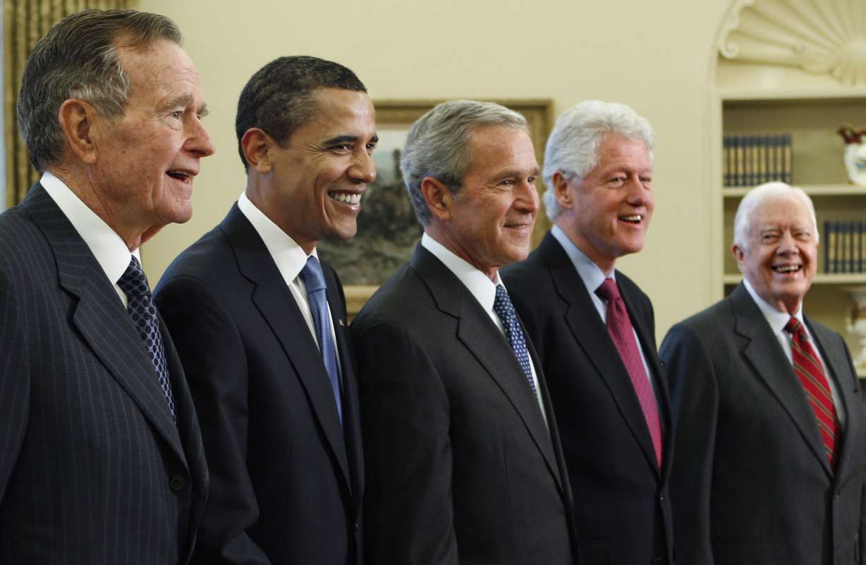 FILE - In this Jan. 7, 2009, file photo, President George W. Bush, center, poses with President-elect Barack Obama, second left, and former presidents, George H.W. Bush, left, Bill Clinton, second right, and Jimmy Carter, right, in the Oval Office of the White House in Washington. Bush has died at age 94. (AP Photo/J. Scott Applewhite, File)