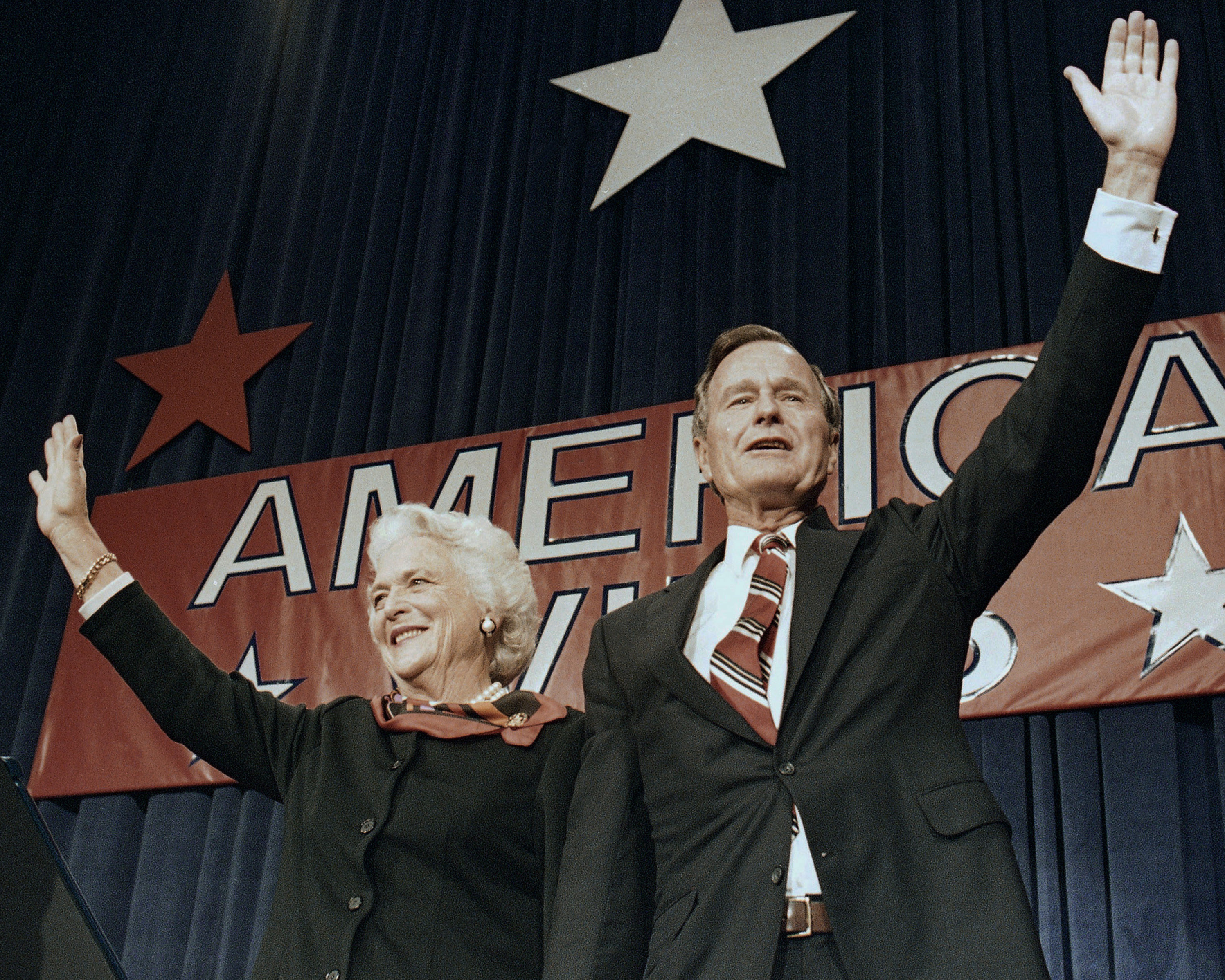 FILE - In this Nov. 8, 1988 file photo, President-elect George H.W. Bush and his wife Barbara wave to supporters in Houston, Texas after winning the presidential election. Bush has died at age 94. (AP Photo/Scott Applewhite, File)