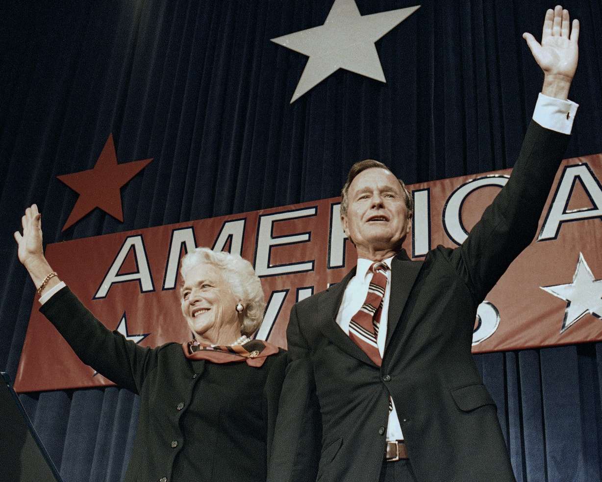 FILE - In this Nov. 8, 1988 file photo, President-elect George H.W. Bush and his wife Barbara wave to supporters in Houston, Texas after winning the presidential election. Bush has died at age 94. (AP Photo/Scott Applewhite, File)