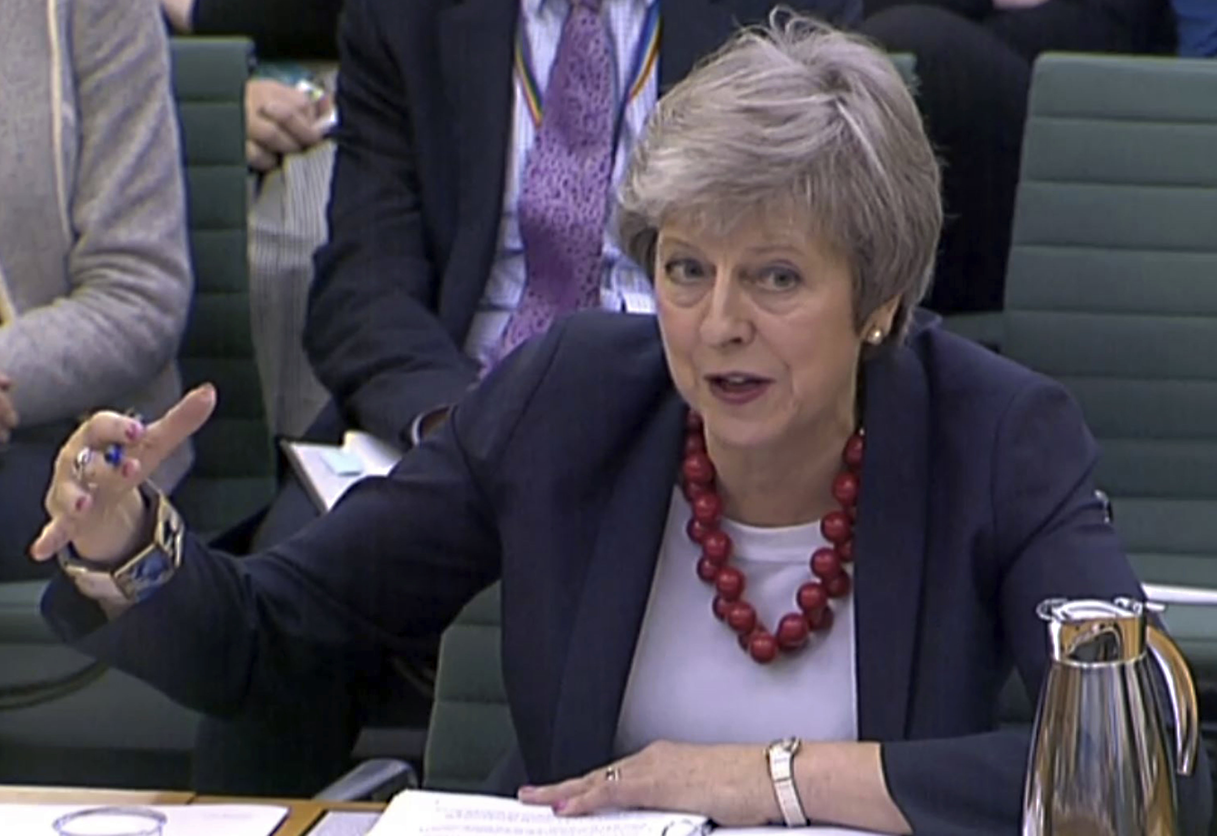 May presses on with Brexit plan after another minister quits