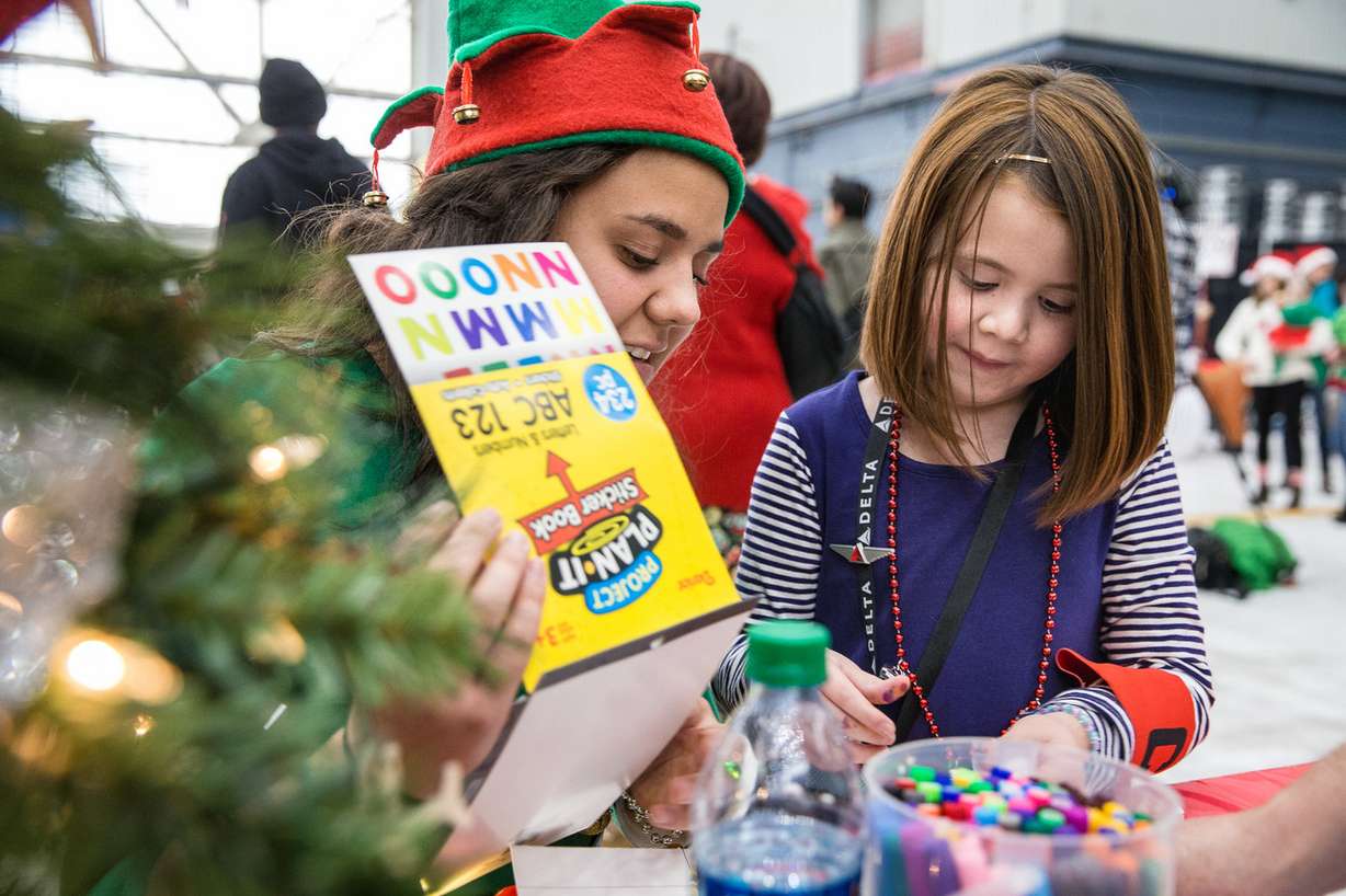 Stella Hogelin, 7, draws a picture at the Delta Delta Air Lines hangar in Salt Lake City, which was transformed into Santa’s Winter Wonderland on Saturday, Dec. 1, 2018. (Photo: Qiling Wang, KSL)