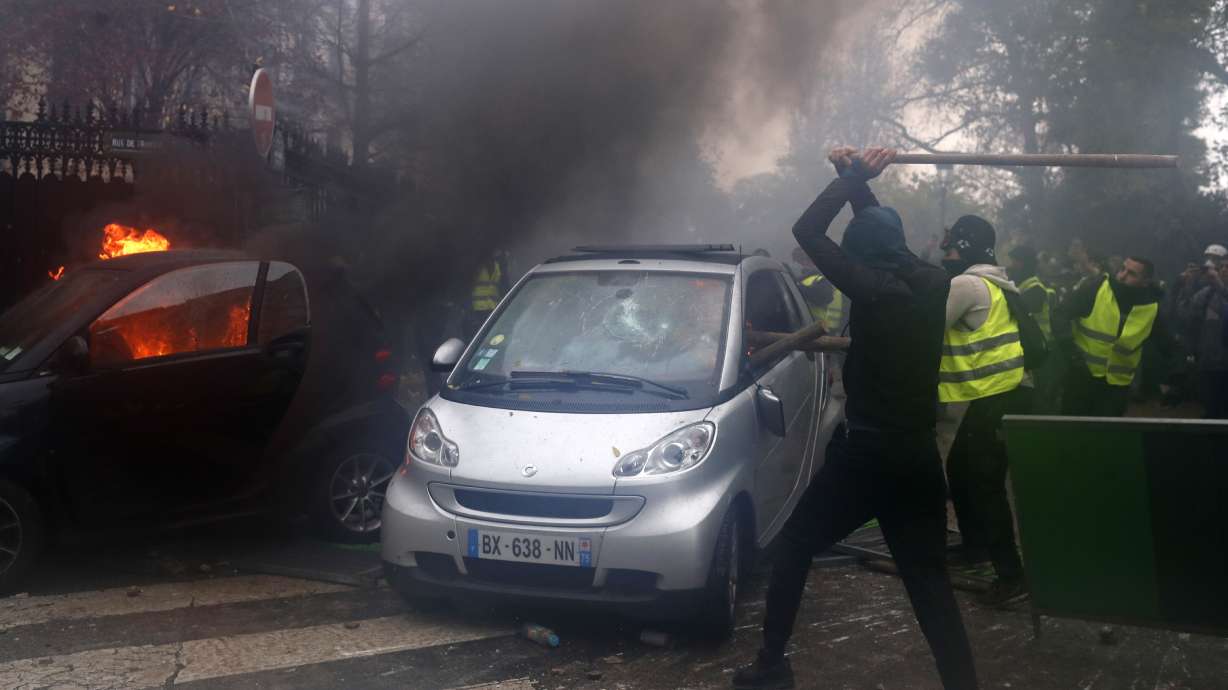 The Latest: Paris police chief says 112 cars torched in riot