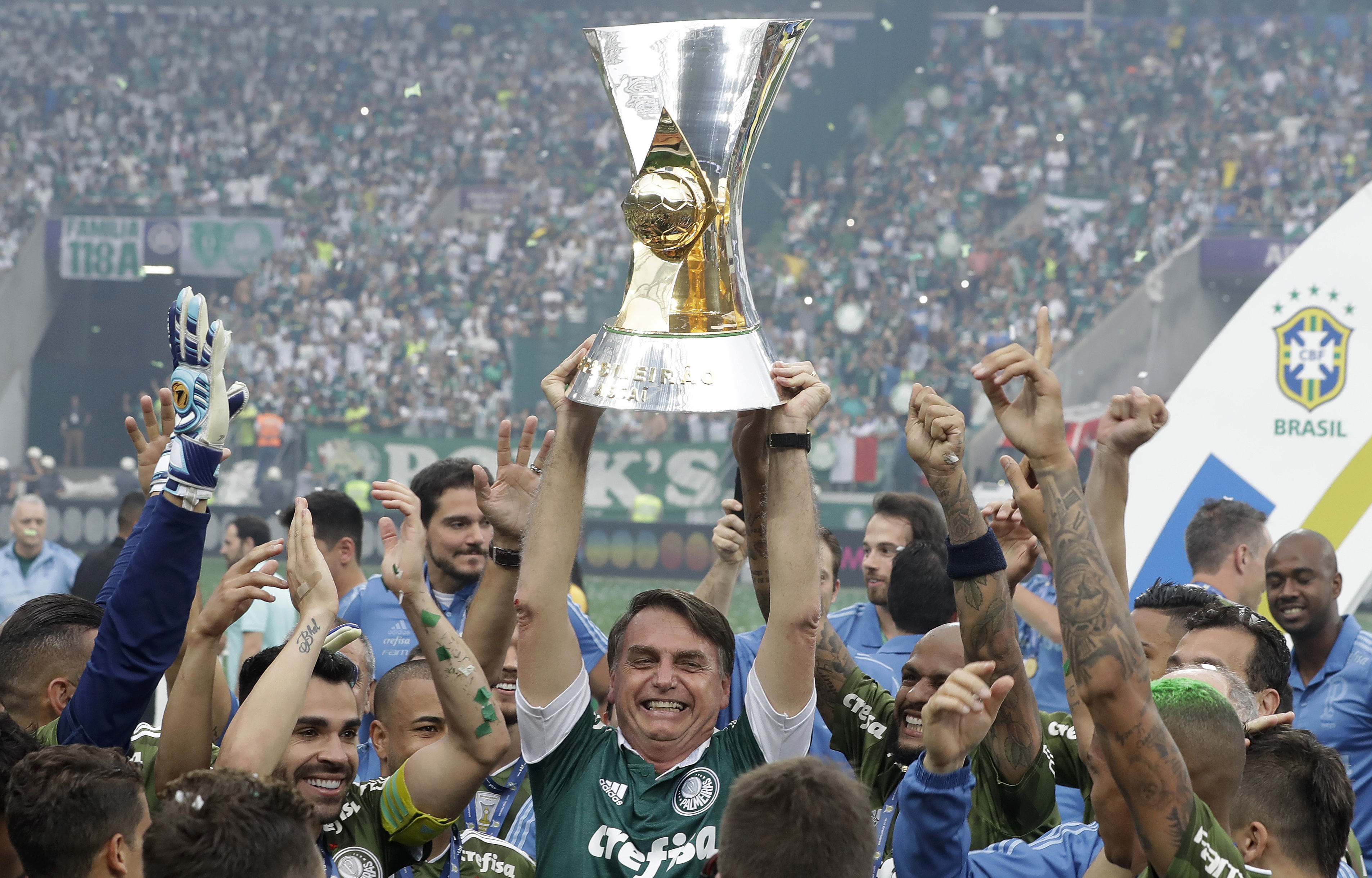 Jeers and cheers as Bolsonaro hands trophy to Palmeiras