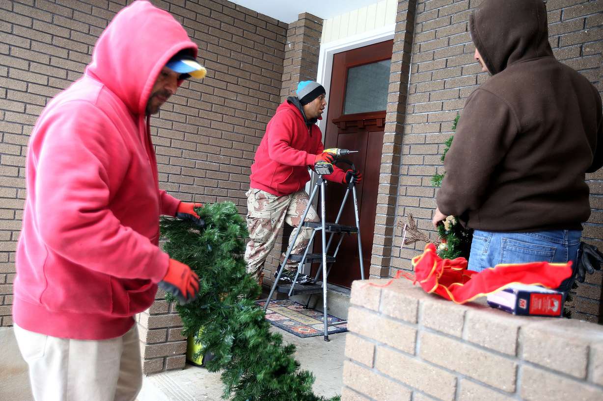 Marco Espinoza, Jose Saucedo and Samuel Gomez, of Ben Lomond Landscape Maintenance, decorate the home of Maj. Brent Taylor in North Ogden on Wednesday, Dec. 5, 2018. The family was nominated for the Decorated Family Program, a national program that was created by Christmas Decor to thank our country’s soldiers for their dedication and support by surprising them and decorating their family’s homes free of charge. Brent Taylor, a major in the Utah Army National Guard who served as North Ogden mayor, died Nov. 3, 2018, while on a deployment to Afghanistan. (Photo: Laura Seitz, KSL)