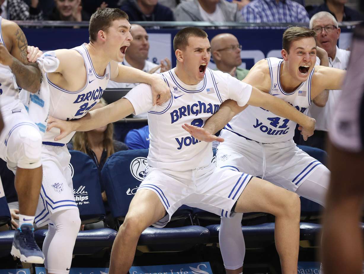 BYU guard McKay Cannon (24), BYU guard Zac Seljaas (2) and BYU forward Luke Worthington (41) celebrate a three pointer in Provo on Wednesday, Dec. 5, 2018. BYU won 95-80. (Photo: Jeffrey D. Allred, Deseret News)