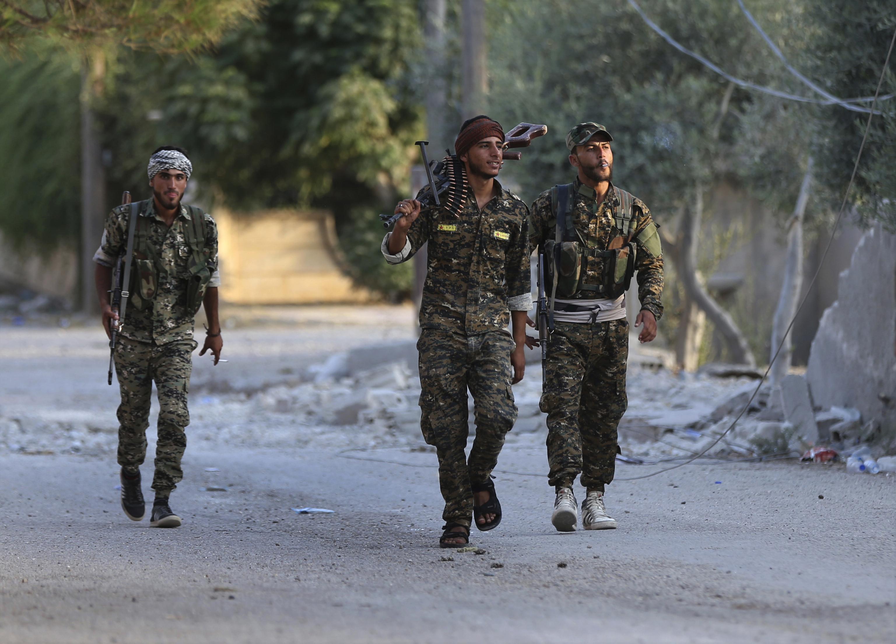 After defeat in Iraq, IS fights on in last enclave in Syria