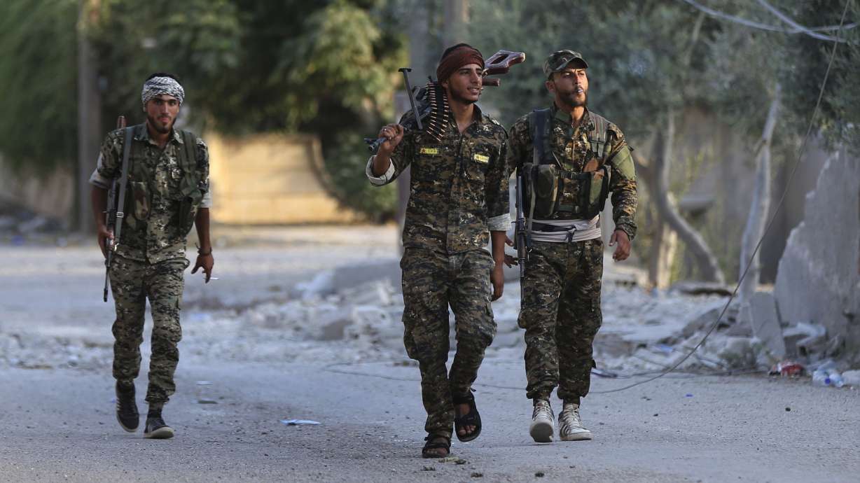 After defeat in Iraq, IS fights on in last enclave in Syria