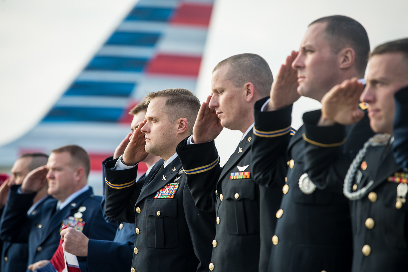 Service members salute as an American Airlines plane gets ready to take off during the annual Snowball Express, an event for children and spouses of fallen military heroes, at the Salt Lake City International Airport on Saturday, Dec. 8, 2018. (Photo: Qiling Wang, KSL)