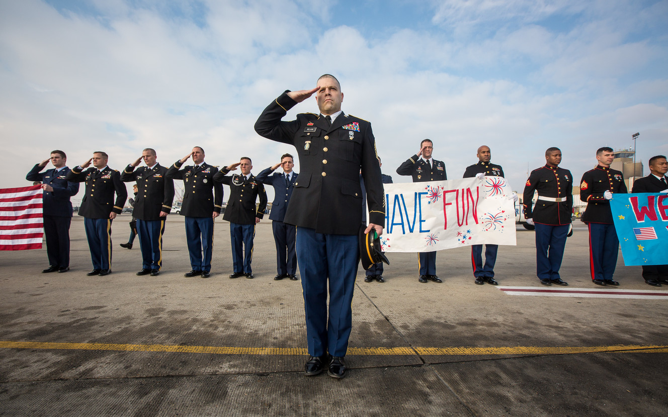 Service members salute as an American Airlines plane is backed out prior to takeoff during the annual Snowball Express, an event for children and spouses of fallen military heroes, at the Salt Lake City International Airport on Saturday, Dec. 8, 2018. (Photo: Qiling Wang, KSL)