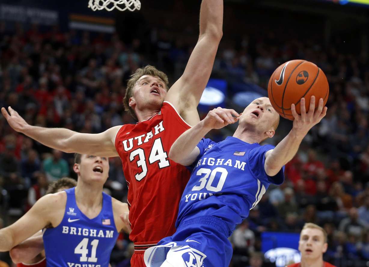 BYU guard TJ Haws (30) drives to the basket as Utah center Jayce Johnson (34) defends in the first half during an NCAA college basketball game Saturday Dec. 8, 2018, in Salt Lake City. (Photo: Rick Bowmer, AP)