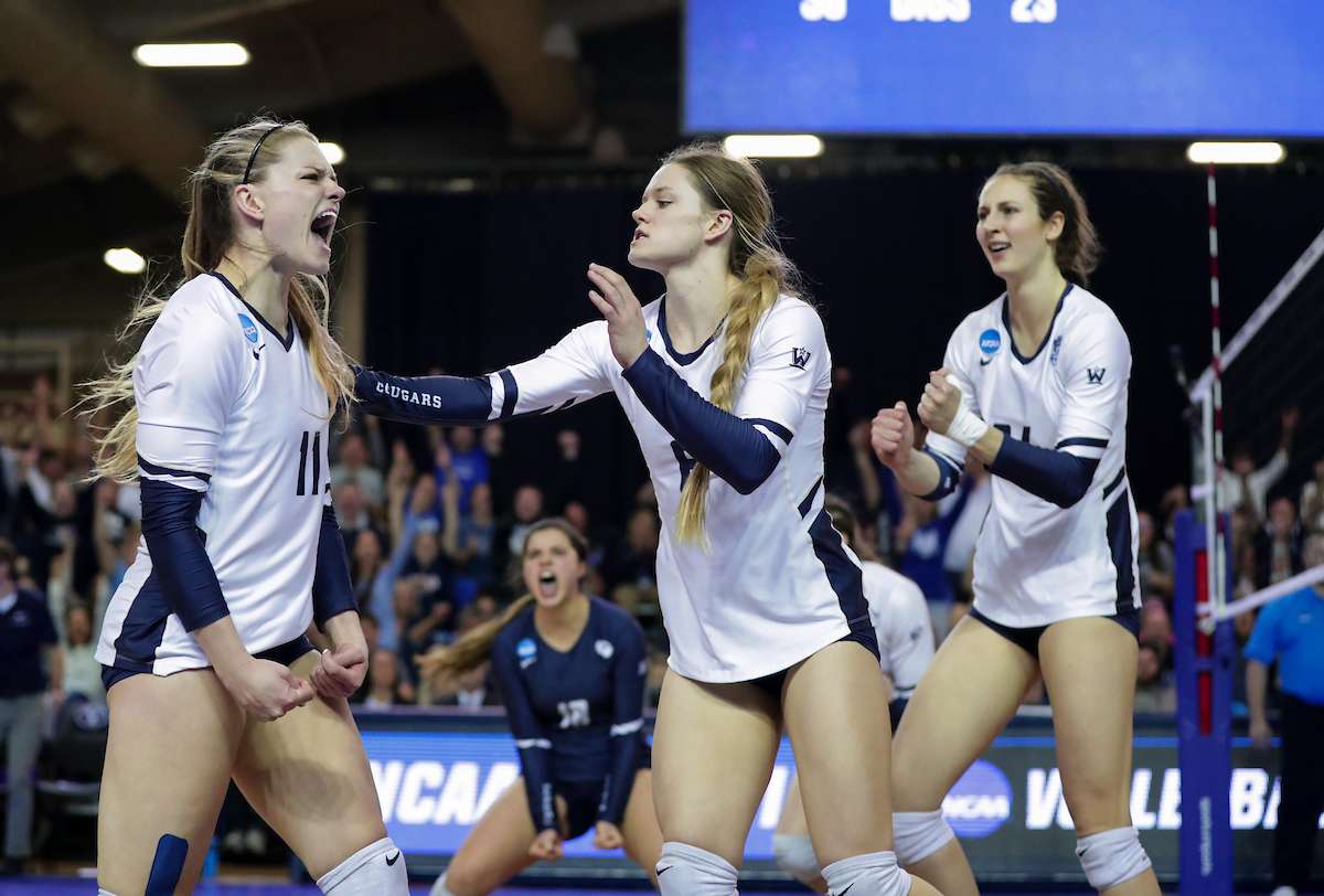 Lacy Haddock (11) and Lyndie Haddock-Eppic celebrate a point late in the third set as the BYU women's volleyball team defeated No. 5 Texas 3-0 in the regional final of the NCAA Women's Volleyball Championships. (Photo: Jaren Wilkey, BYU Photo)