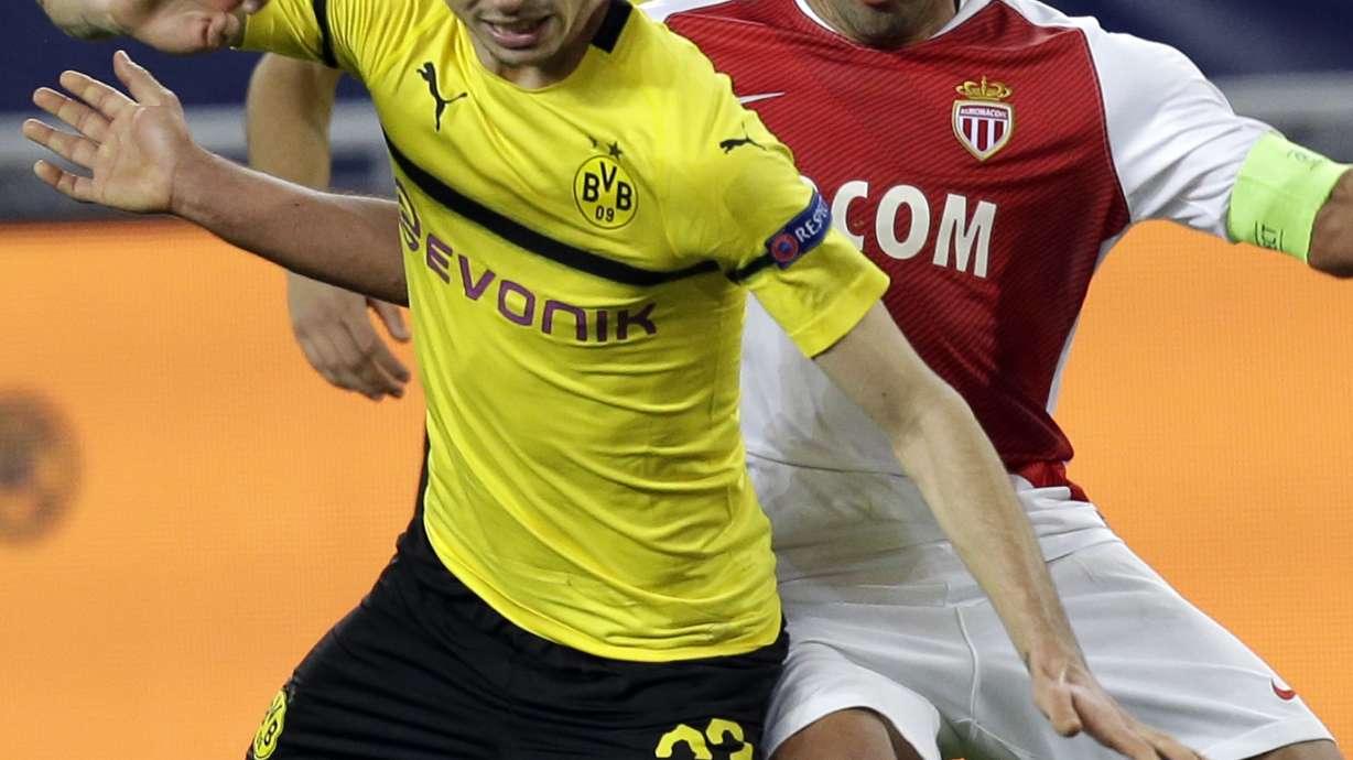 Dortmund secures top spot with 2-0 win at Monaco