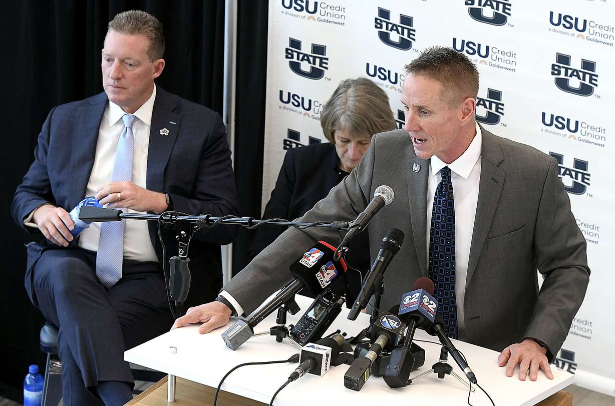 Athletics Director John Hartwell, left, and President Noelle Cockett listen as Gary Andersen speaks at a press conference where he was introduced as the new head football coach at Utah State, Tuesday, Dec. 11, 2018, in Logan, Utah. (Photo: Eli Lucero, The Herald Journal via AP)