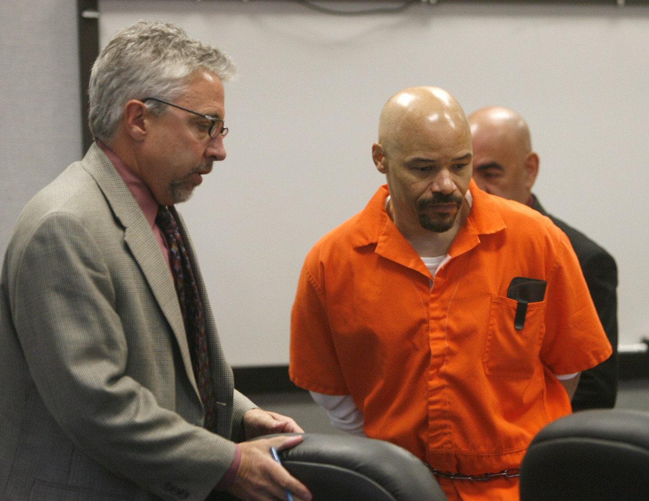 Defense lawyer Mark Moffat, left, clears a spot at the table for death row inmate Douglas Stewart Carter during a hearing in Provo's 4th District Court in October 2007.