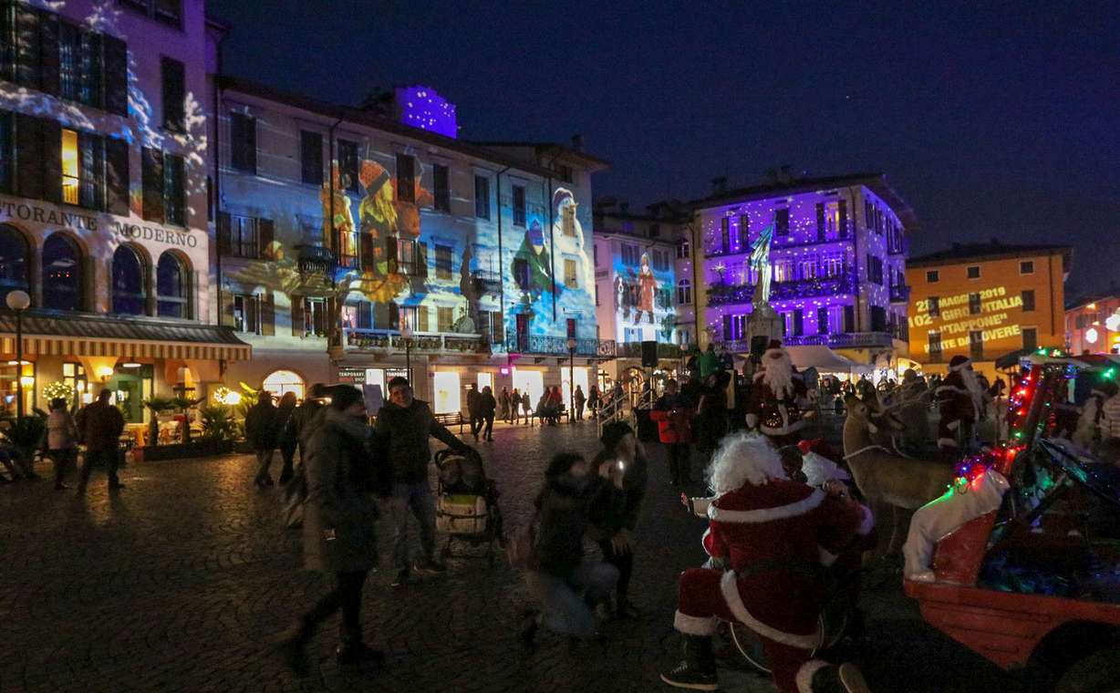 Spectators gather in Lovere, Italy during the "Lovere, Il Borgo Della Luce" art display. Utah artist Robert Duncan's work is being featured for the third annual edition of the town's art installation, in which artwork is projected onto the sides of buildings. (Photo: Alfredo Stella)