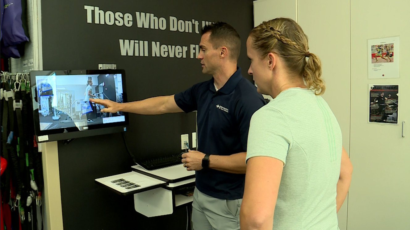 Sports performance trainer Brennan Ames reviews Jacqui Knighton's gait analysis. (Photo: KSL TV)