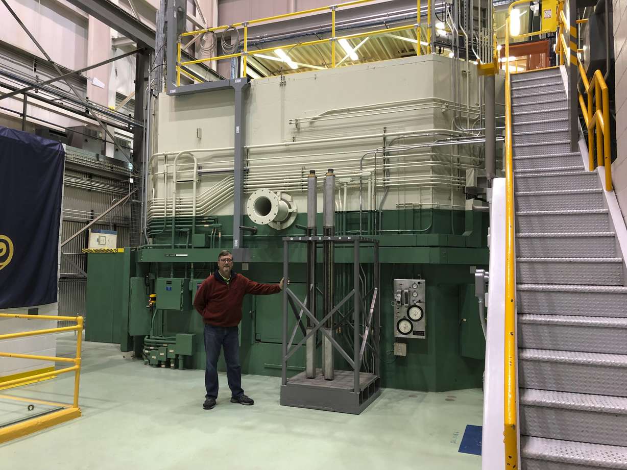 In this Nov. 29, 2018 photo, J.R. Biggs stands in front of the Transient Test Reactor he manages in Idaho Falls, Idaho. The test reactor at the Idaho National Laboratory has been restarted to test nuclear fuels as the U.S. tries to revamp a fading nuclear power industry with safer fuel designs and a new generation of power plants. (AP Photo/Keith Riddler)