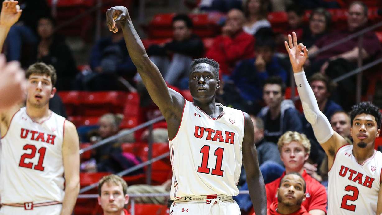 Both Gach after making a basket during a game at the Huntsman Center in Salt Lake City, Utah.