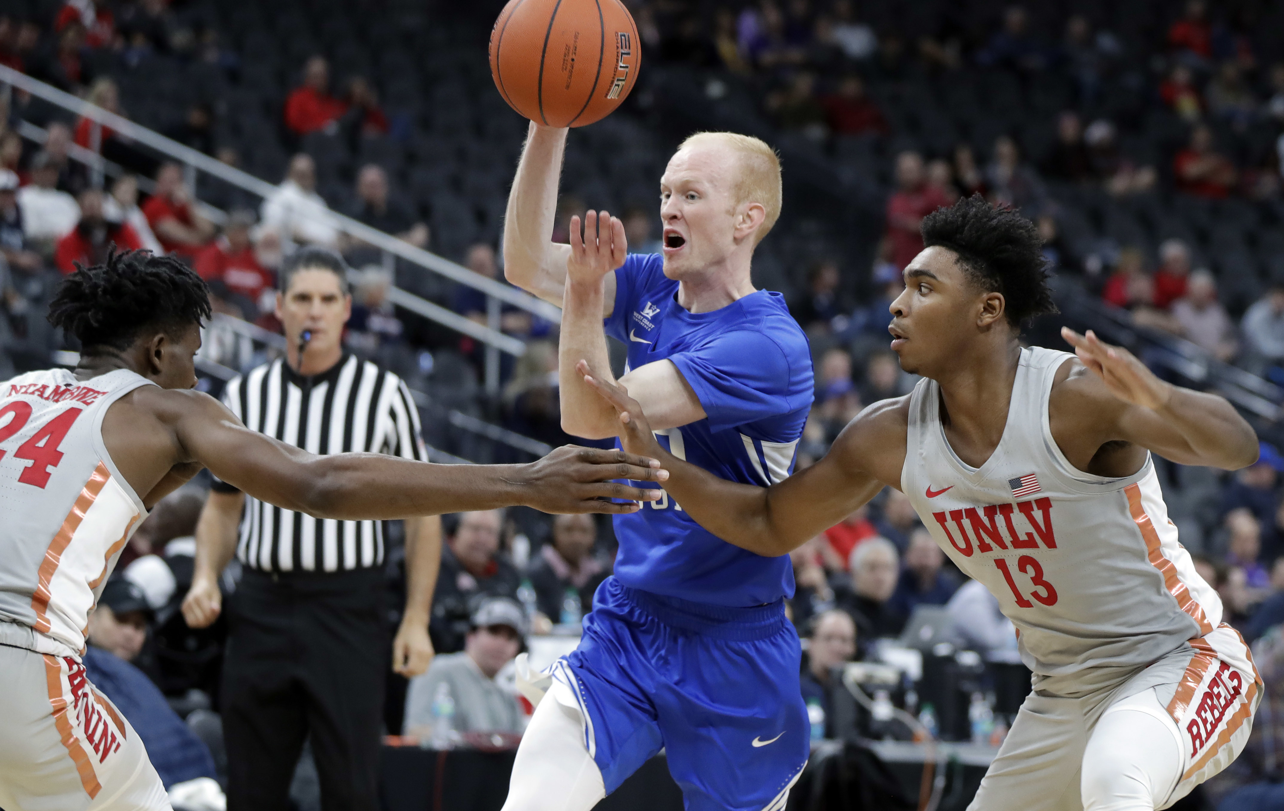 UNLV's Joel Ntambwe (24) and Bryce Hamilton (13) cover a drive by BYU's TJ Haws during the second half of an NCAA college basketball game Saturday, Dec. 15, 2018, in Las Vegas. (Photo: Isaac Brekken, AP)