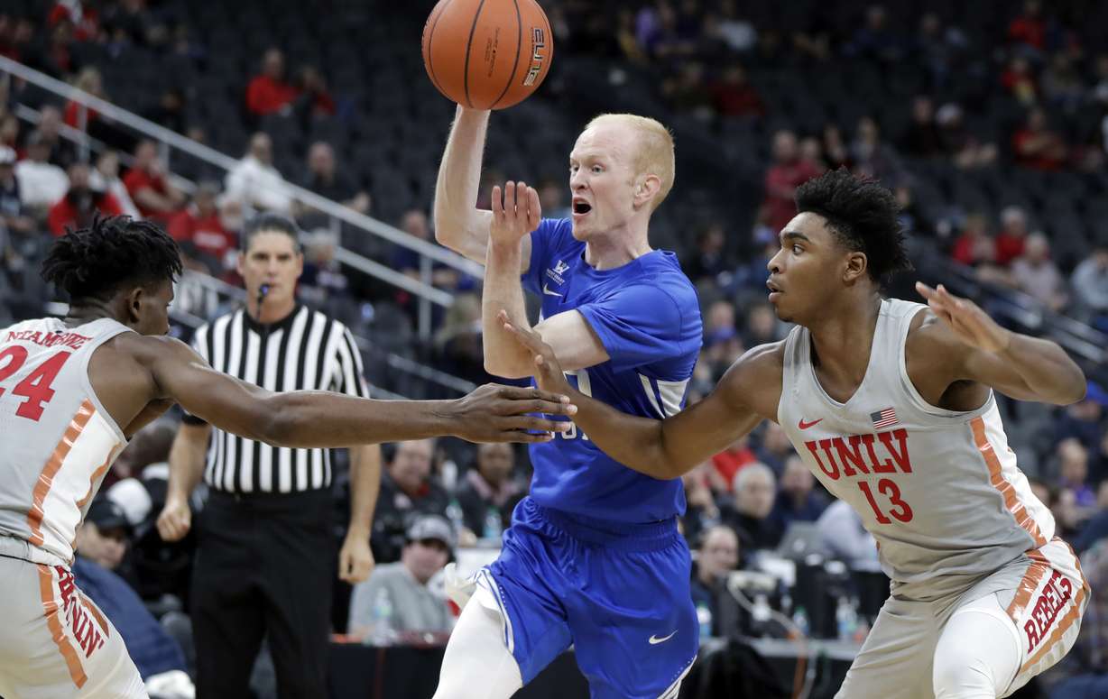 UNLV's Joel Ntambwe (24) and Bryce Hamilton (13) cover a drive by BYU's TJ Haws during the second half of an NCAA college basketball game Saturday, Dec. 15, 2018, in Las Vegas. (Photo: Isaac Brekken, AP)