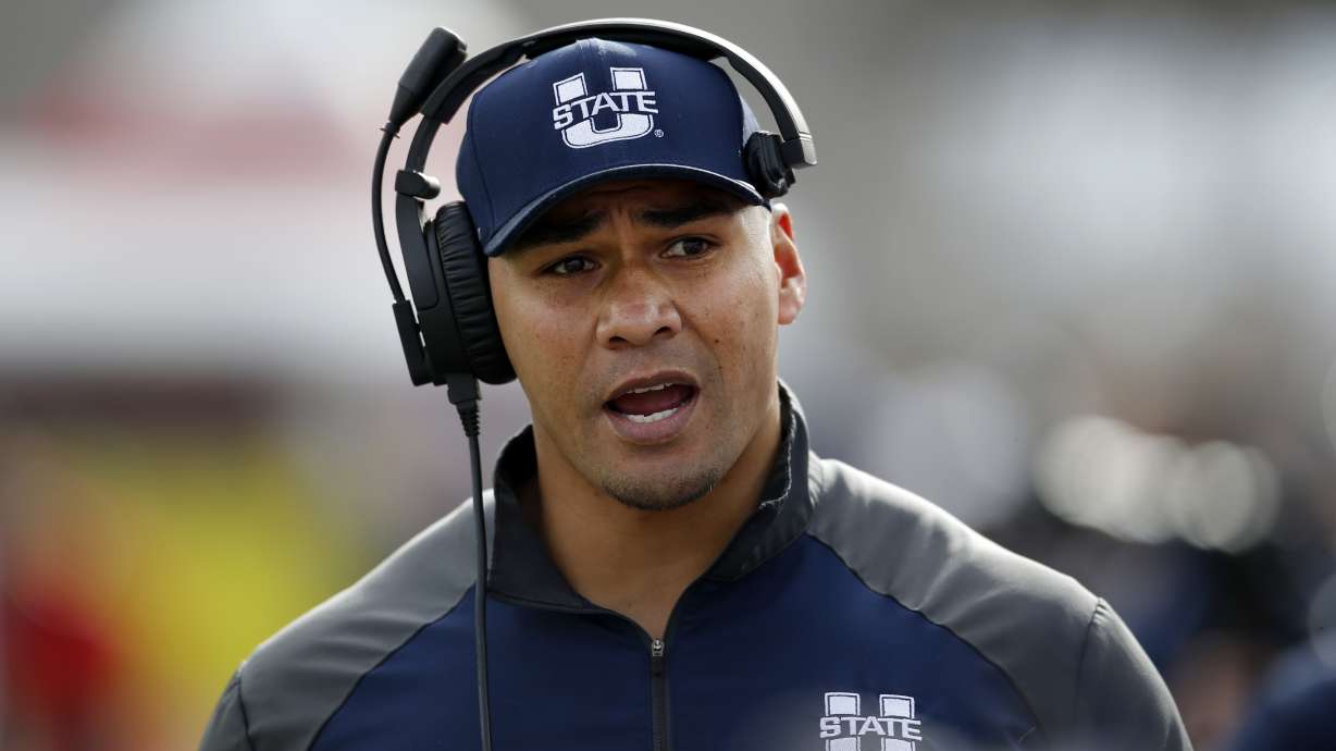 Utah State interim head coach Frank Maile walks the sidelines during the first half of the New Mexico Bowl NCAA college football game against North Texas in Albuquerque, N.M., Saturday, Dec. 15, 2018. (AP Photo/Andres Leighton)