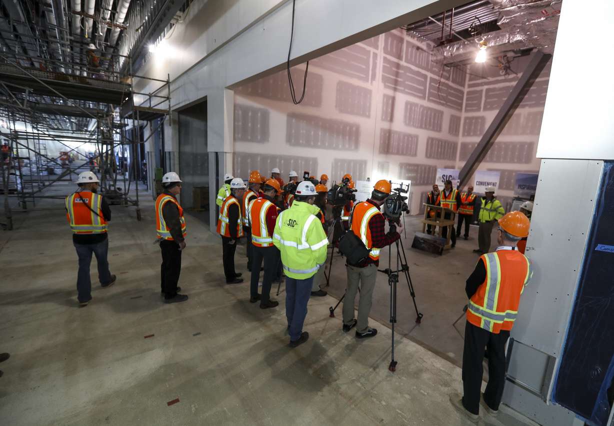 John Buckner, director of administration and commercial services at the Salt Lake City Department of Airports, center, stands in a new retail space as he speaks during a press conference in the new airport under construction in Salt Lake City on Tuesday, Dec. 18, 2018. (Photo: Steve Griffin, KSL)