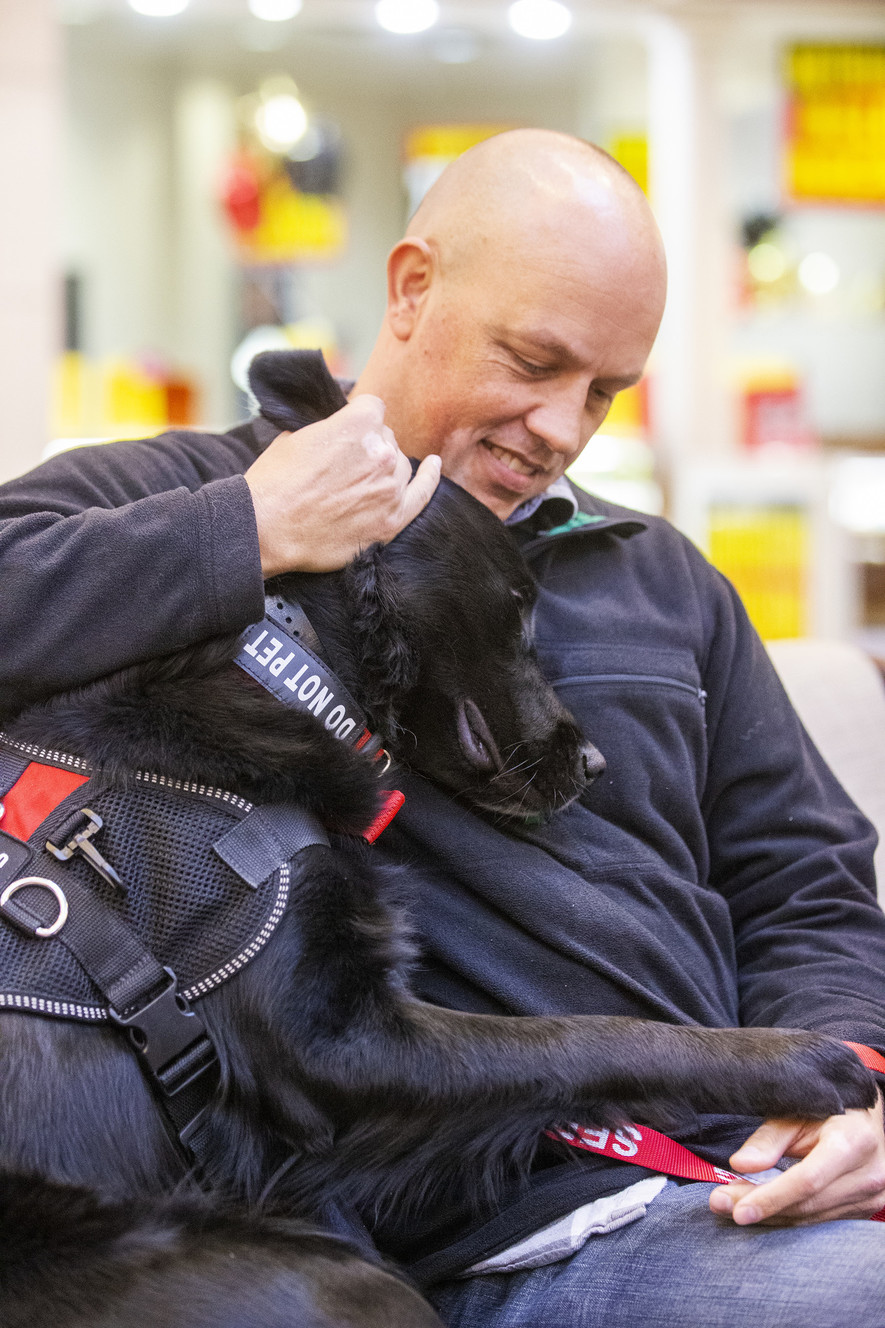 Army veteran Daniel Seelye plays with his new service dog Nick as he and his family attend an event where the veteran is officially given a service dog at Fashion Place Mall in Murray on Wednesday, Dec. 19, 2018. (Photo: Scott G Winterton, KSL)