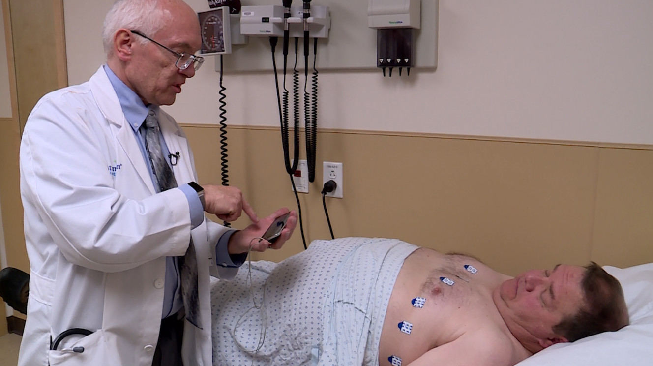 Dr. Brent Muhlestein runs an ECG on patient Morey Day through an app on his smart phone device. (Photo: KSL TV)