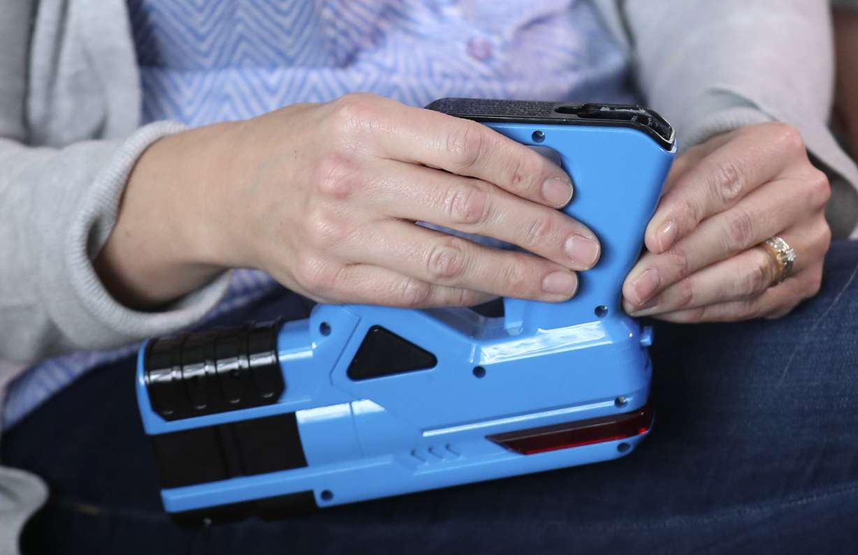 Lesha Kirkwood explains on Thursday, Dec. 27, 2018, how one of the batteries in an infrared laser tag gun set exploded in her son Kempton's face on Christmas morning at their home in Farmington. (Photo: Steve Griffin, KSL)