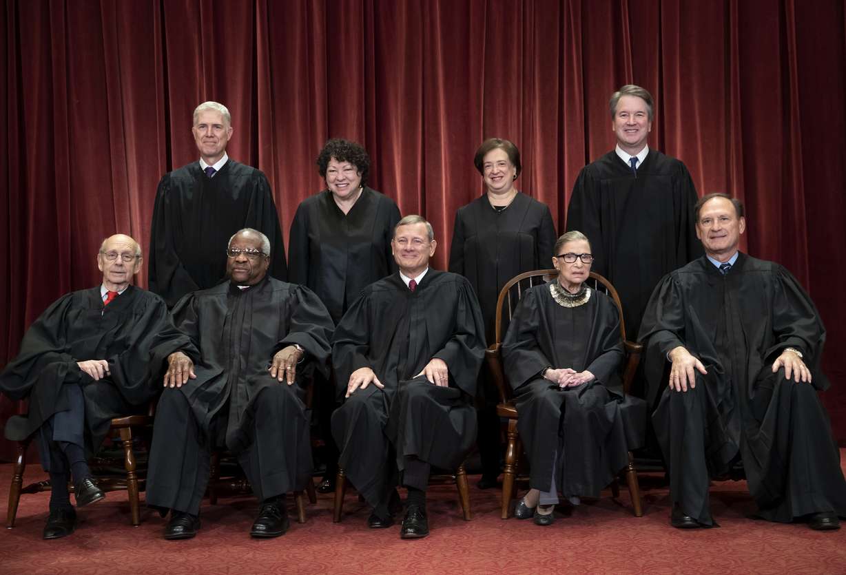 FILE - In this Nov. 30, 2018, file photo, the justices of the U.S. Supreme Court gather for a formal group portrait to include a new Associate Justice, top row, far right, at the Supreme Court Building in Washington. Seated from left: Associate Justice Stephen Breyer, Associate Justice Clarence Thomas, Chief Justice of the United States John G. Roberts, Associate Justice Ruth Bader Ginsburg and Associate Justice Samuel Alito Jr. Standing behind from left: Associate Justice Neil Gorsuch, Associate Justice Sonia Sotomayor, Associate Justice Elena Kagan and Associate Justice Brett M. Kavanaugh.