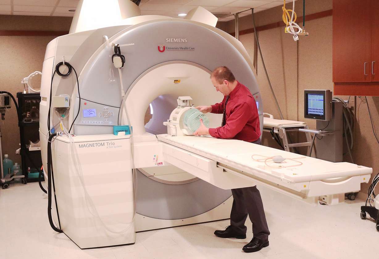 Dr. Jeff Anderson, a professor of radiology and imaging sciences at the University of Utah, preps an MRI scanner at the Imaging and Neurosciences Center in Salt Lake City on Friday, Dec. 28, 2018. U. researchers found MRI scans of patients who have Alzheimer's disease show that playing songs with personal meaning to them activates parts of their brain that still have a semblance of memory retention. (Photo: Jeffrey D. Allred, KSL)