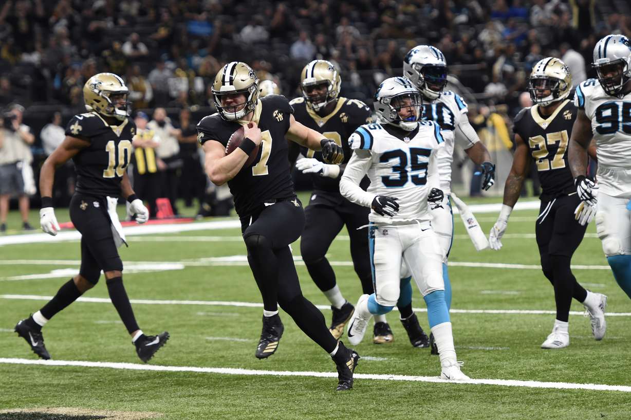 New Orleans Saints quarterback Taysom Hill (7) carries for a touchdown in front of Carolina Panthers cornerback Corn Elder (35) in the second half of an NFL football game in New Orleans, Sunday, Dec. 30, 2018. (Photo: Bill Feig, AP)