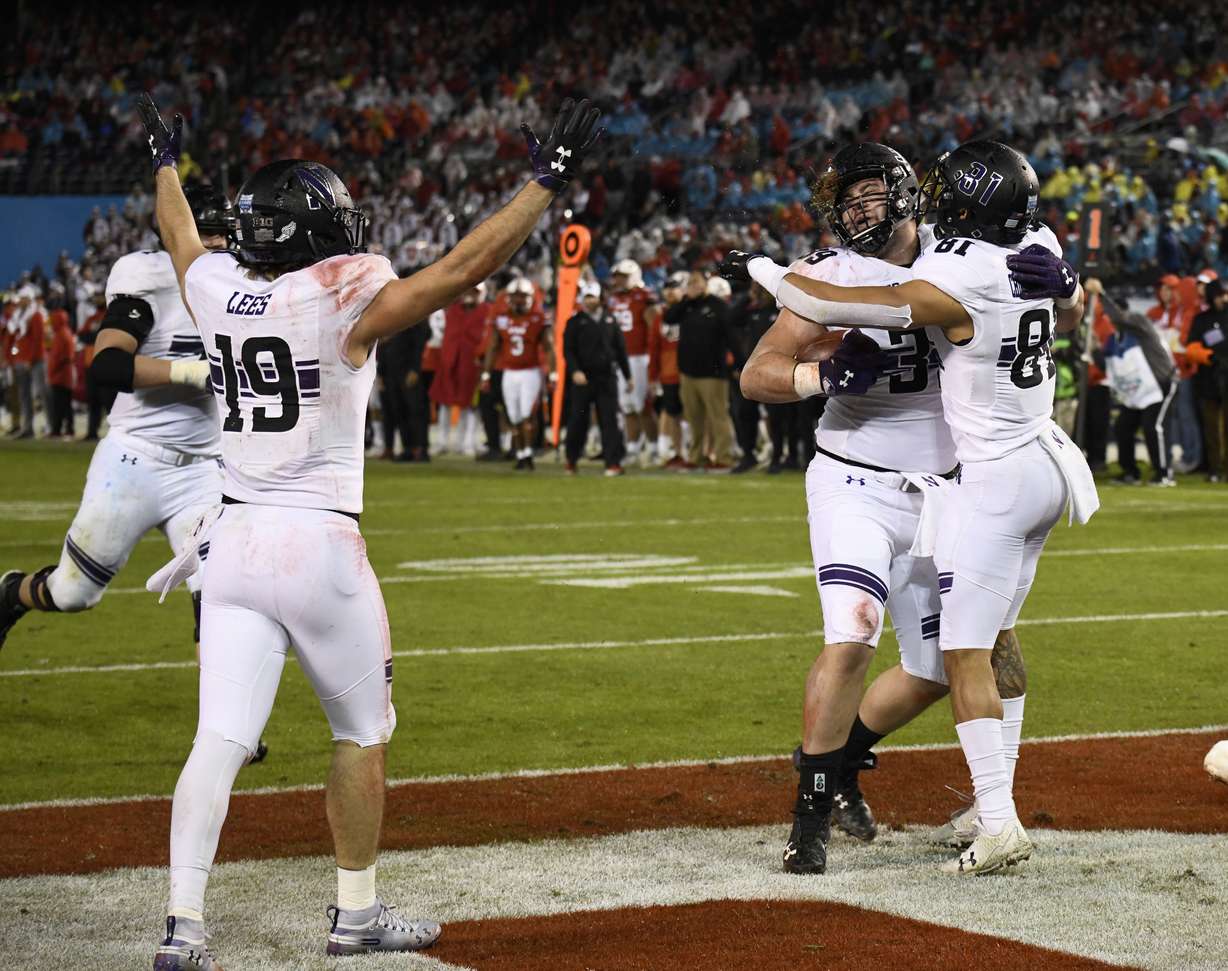 Northwestern offensive lineman Trey Klock (39), center, is congratulated by wide receiver Ramaud Chiaokhiao-Bowman (81) after scoring a touchdown during the second half of the Holiday Bowl NCAA college football game against Utah, Monday, Dec. 31, 2018, in San Diego. (Photo: Denis Poroy, AP)