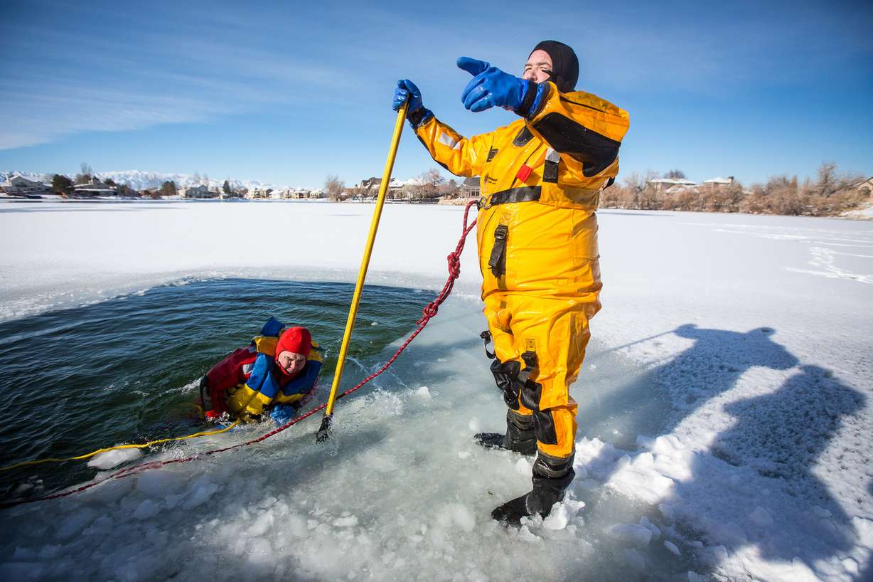 Cody Howard, left, and Eric Wilden break the ice before the sixth annual Polar Plunge at Stansbury Lake in Stansbury Park on Tuesday, Jan. 1, 2019. (Photo: Qiling Wang, KSL)