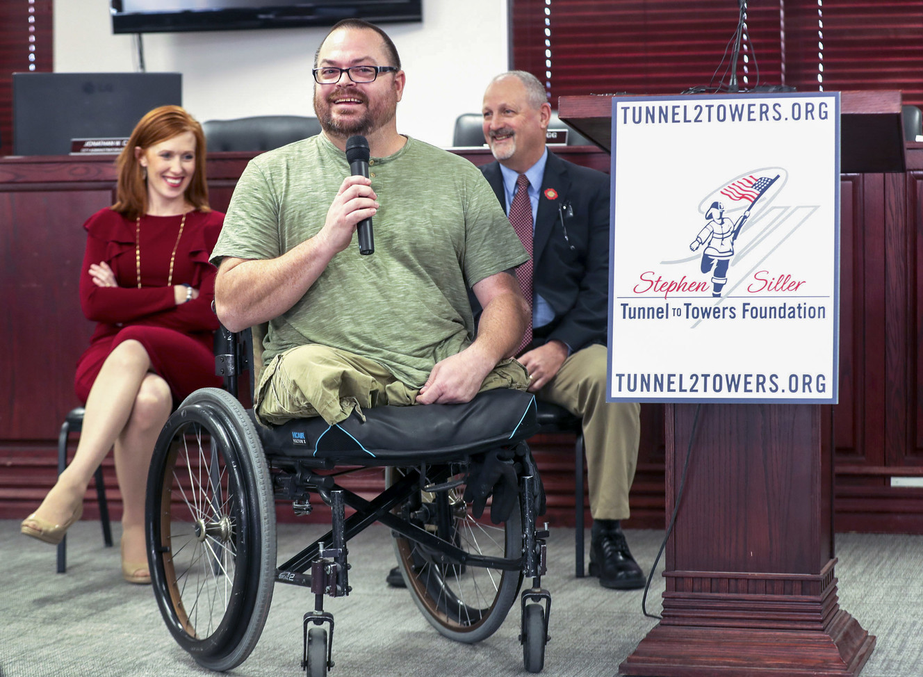 Jennie Taylor, widow of North Ogden Mayor Maj. Brent Taylor, left, and Frank Siller, chairman and CEO of Stephen Siller Tunnel to Towers Foundation, listen as Army Sgt. 1st Class Travis Vendela, talks about his physical struggles living in his current home in Kaysvile during a press conference at the North Ogden Municipal Building on Thursday, Jan. 3, 2019. Vendela lost both legs above the knee in Iraq in 2007. (Photo: Steve Griffin, KSL)