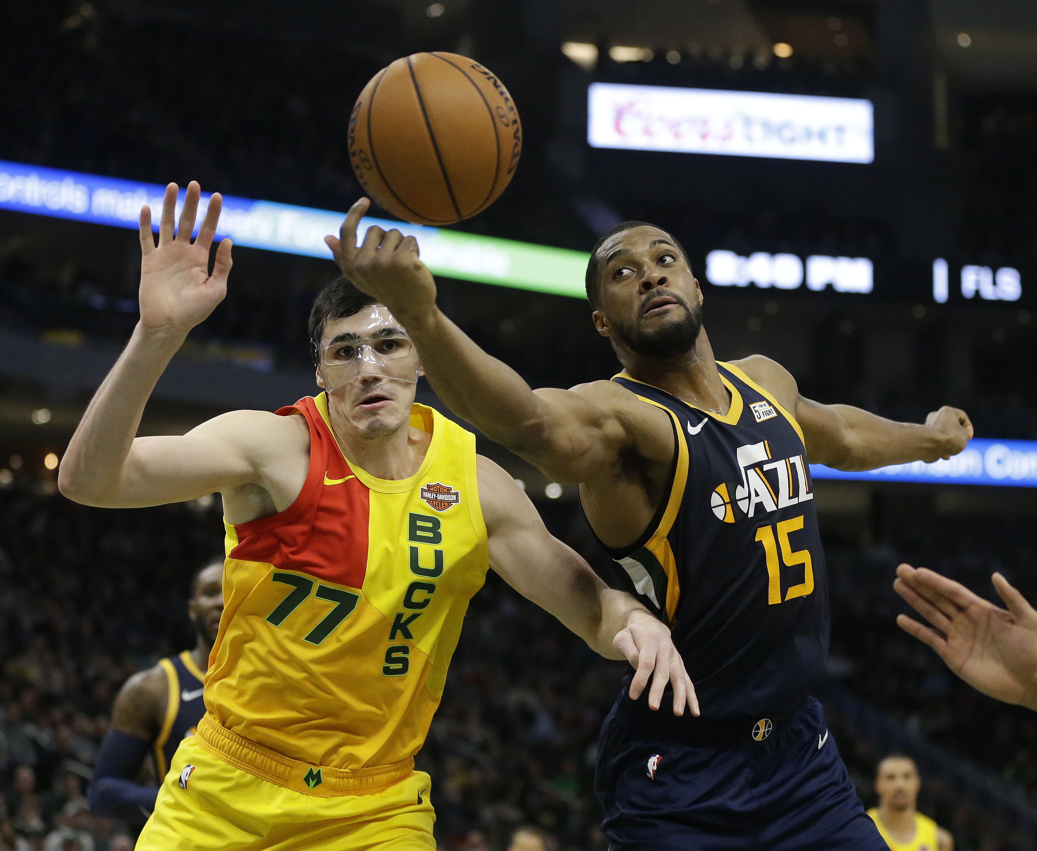 Utah Jazz's Derrick Favors (15) and Milwaukee Bucks' Ersan Ilyasova (77) fight for a rebound during the second half of an NBA basketball game Monday, Jan. 7, 2019, in Milwaukee. (Photo: Aaron Gash, AP)