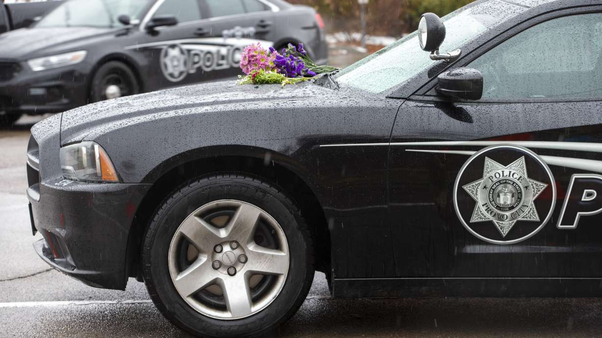 Flowers are placed on the car of slain Provo police officer Joseph Shinners Jan. 6, 2019 in Provo. The trial for the man accused of murdering Shinners began Friday, over five years after his death.