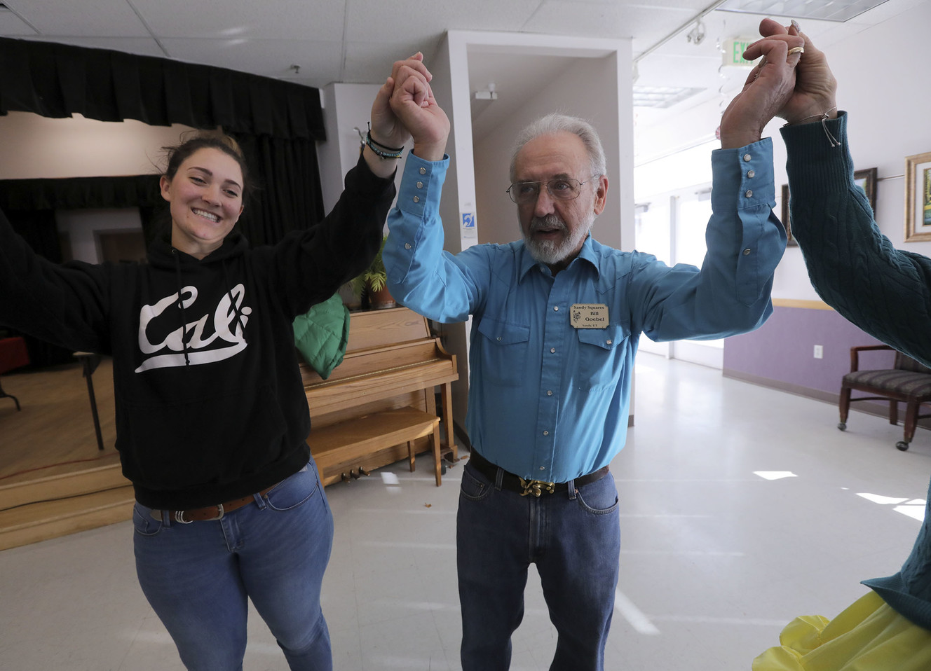 Juan Diego High School senior Grace Anglesey and Bill Goebel raise their hands after square dancing at the Sandy Senior Citizens Center in Sandy on Wednesday, Jan. 9, 2019. Photo: Kristin Murphy, KSL