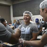Vivint sales reps don hair nets, assemble more than a quarter million meals for orphans worldwide